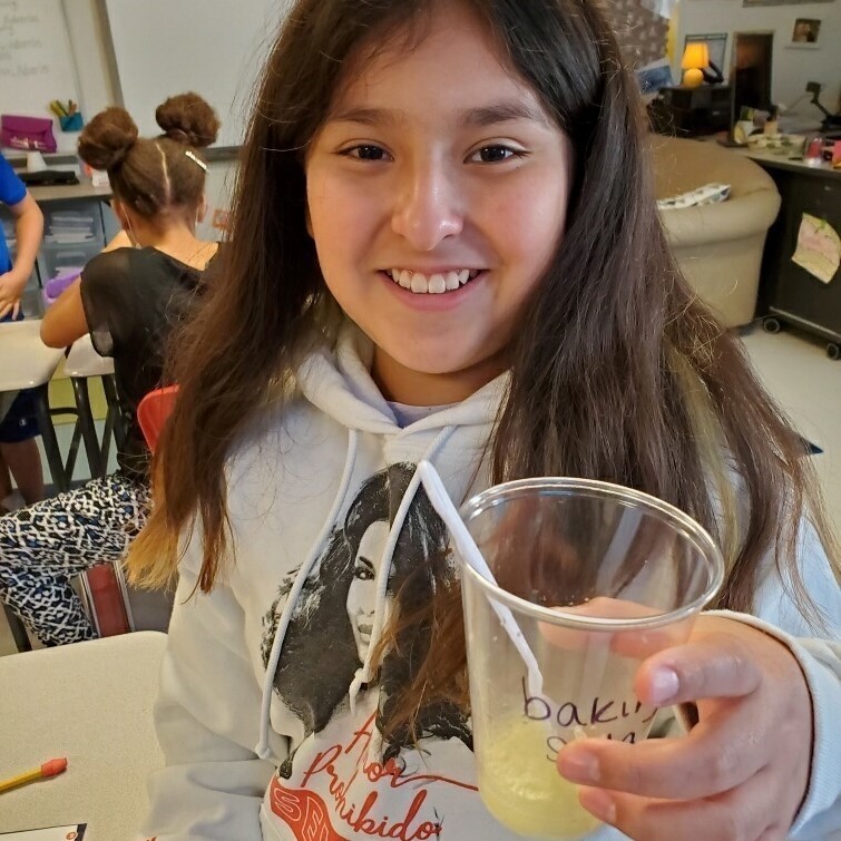 girl holding  a cup with baking soda