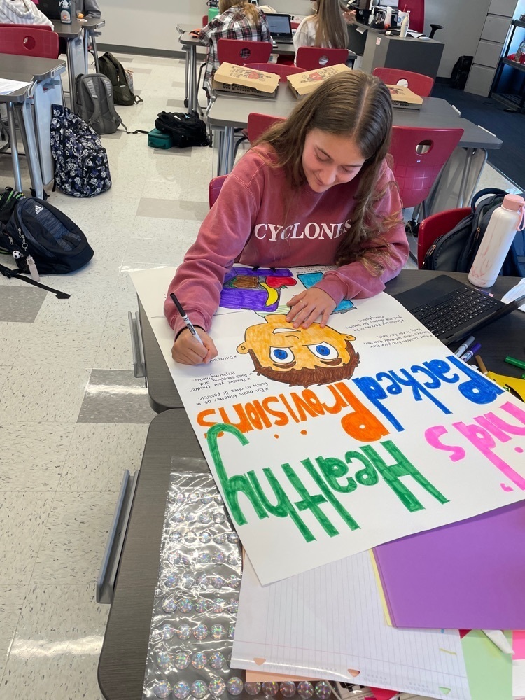 student working on a poster