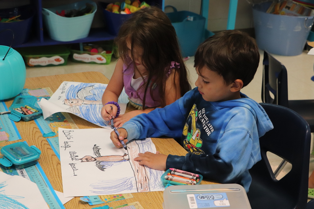 two kids coloring bats