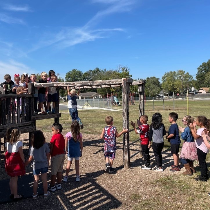 kindergarten students take this expectation seriously, as they cheer each other on, on the playground monkey bars!