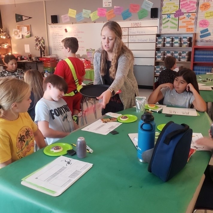 miss bart serves a group of students snacks