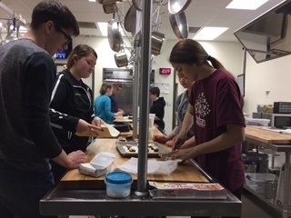 Spanish 4 students make pastelitos de guayaba in the kitchen