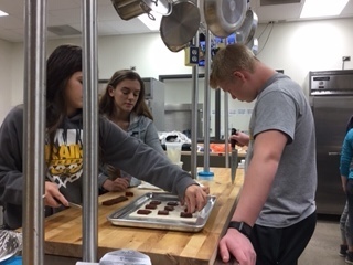 Spanish 4 students make pastelitos de guayaba in the kitchen