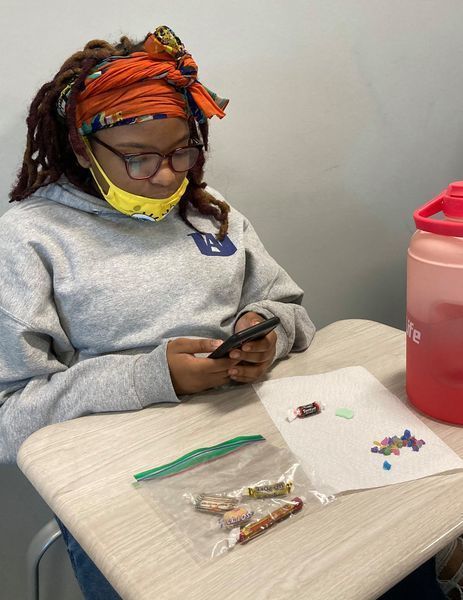 Student calculating the amount of candy in a jar