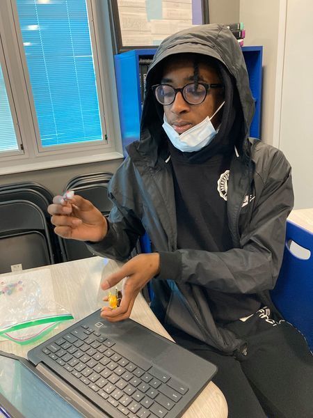 Student calculating the amount of candy in a jar