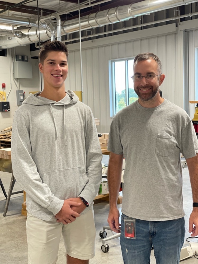  student posing with adult 