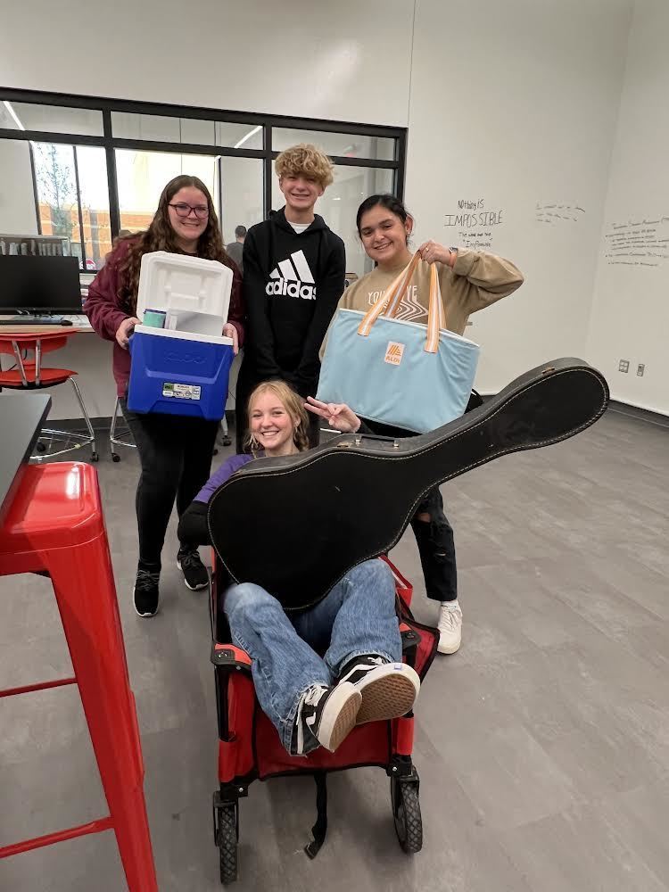 students with coolers, totes, and a wagon