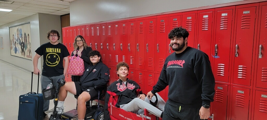 students with suitcase & shopping cart