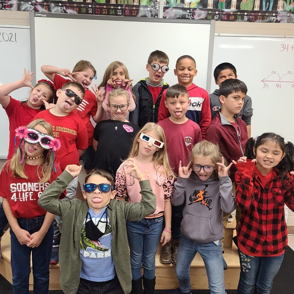 class of students  in red shirts and silly glasses