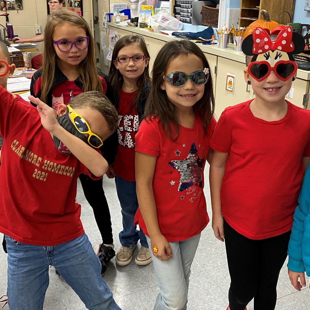 elementary students in red shirts and glasses