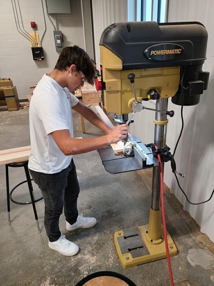student working with wood