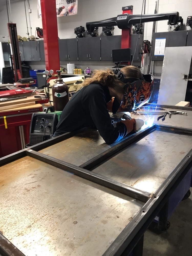 student welding 