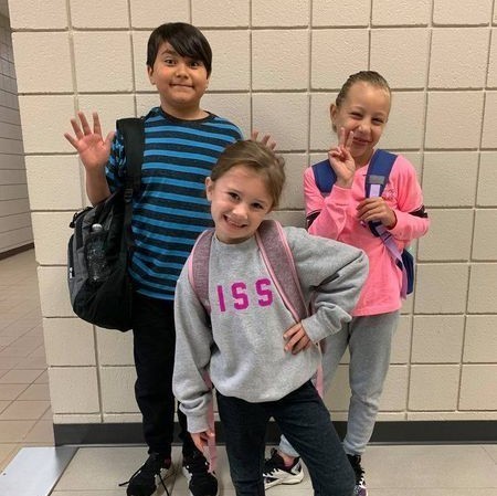 boy and two girls in sweats