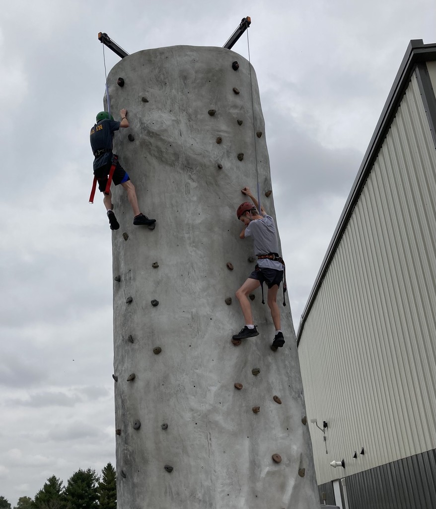 Students climbing rock wall