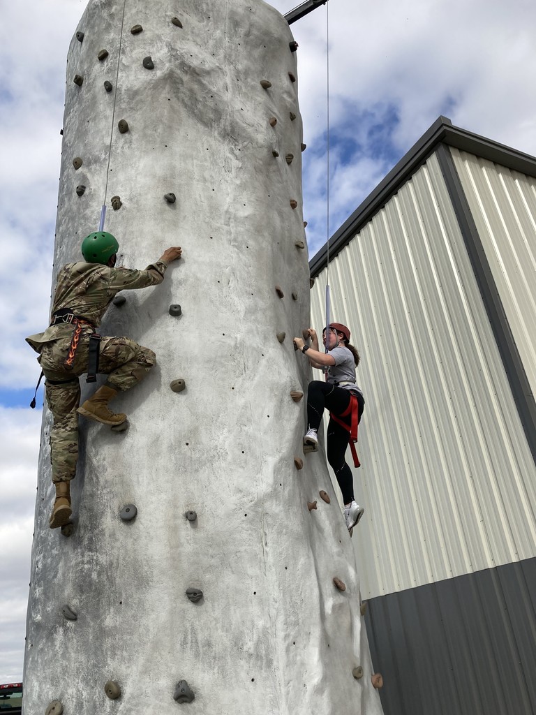 Students climbing rock wall