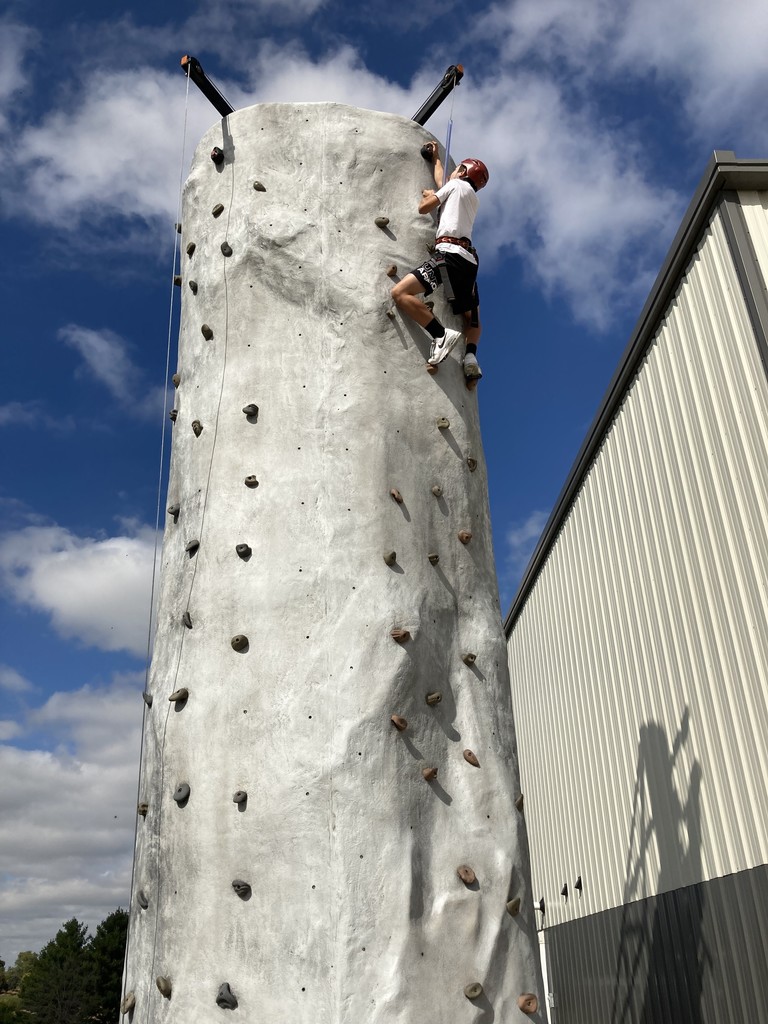 Students climbing rock wall