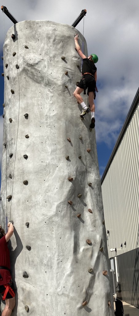 Students climbing rock wall