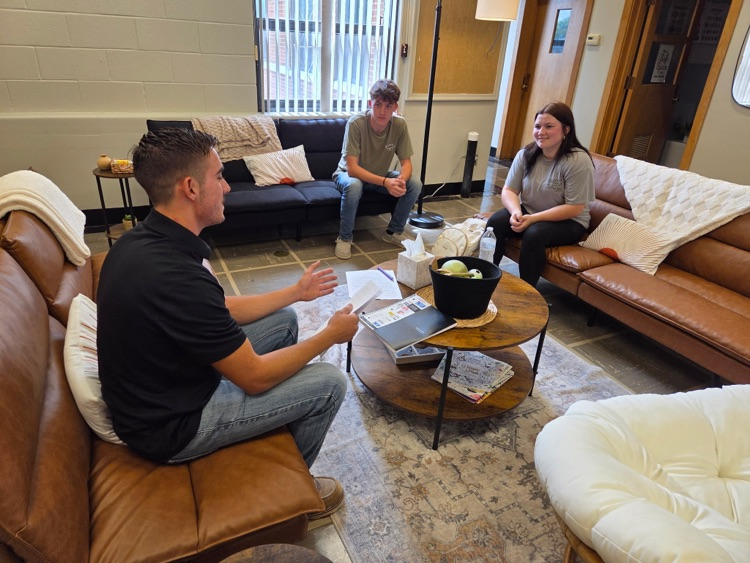 3 students discuss ideas in the student service center