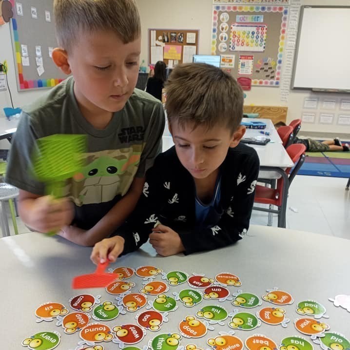 boys with swatters and cards on table