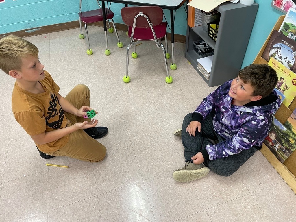 two boys on the floor with dice