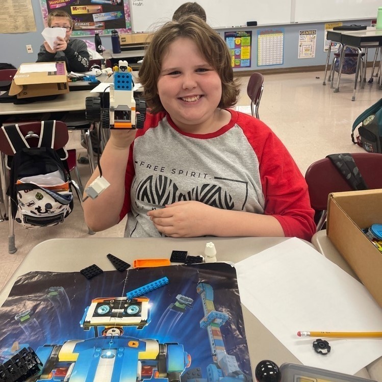 student building a lego robot