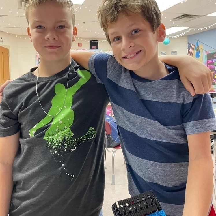 tow boys arms around each other