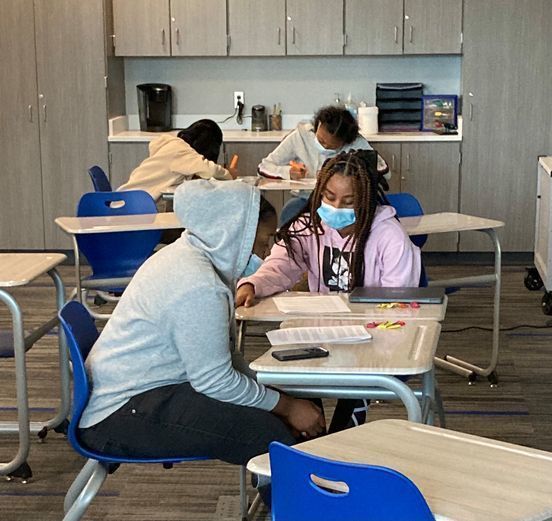 Students reading and working on school work