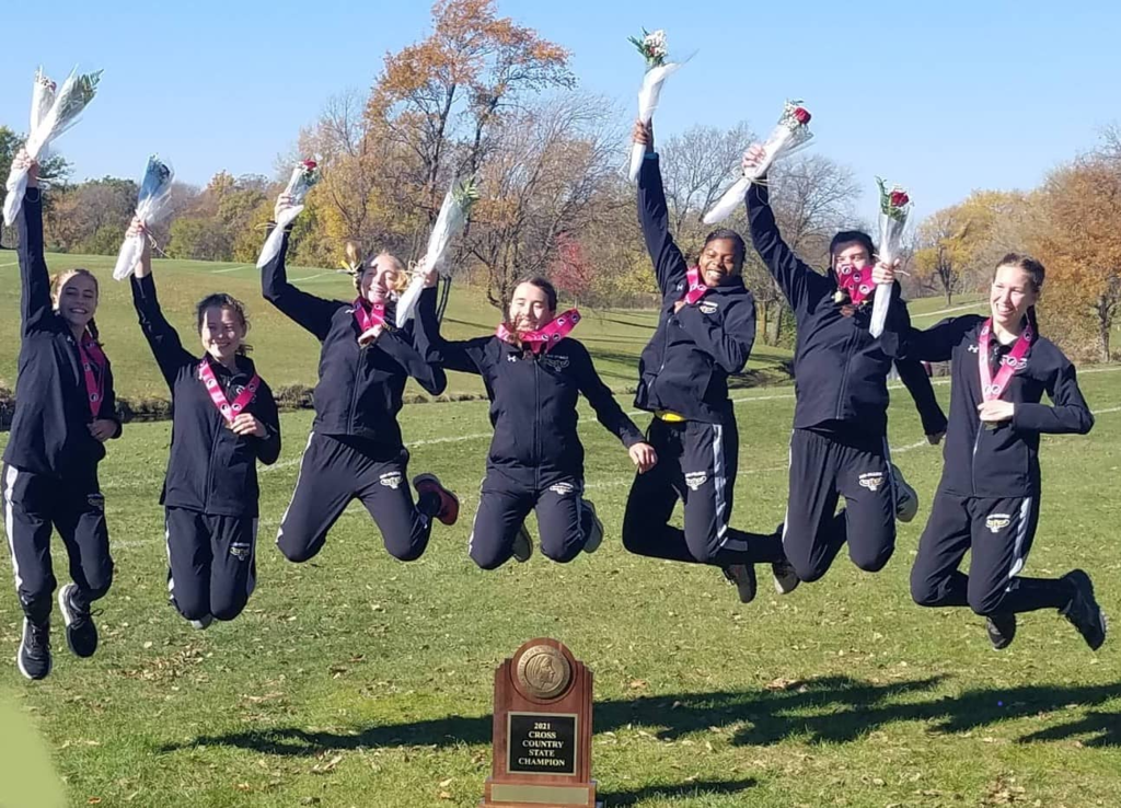 Girl's cross country team with trophy