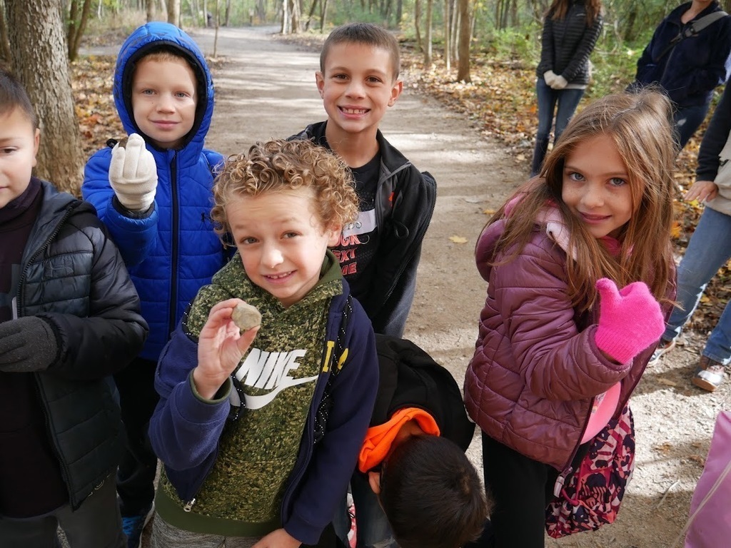 Students showing their finds from their hike.