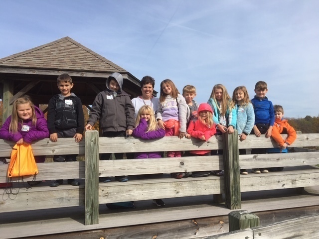 Children lining the fence.