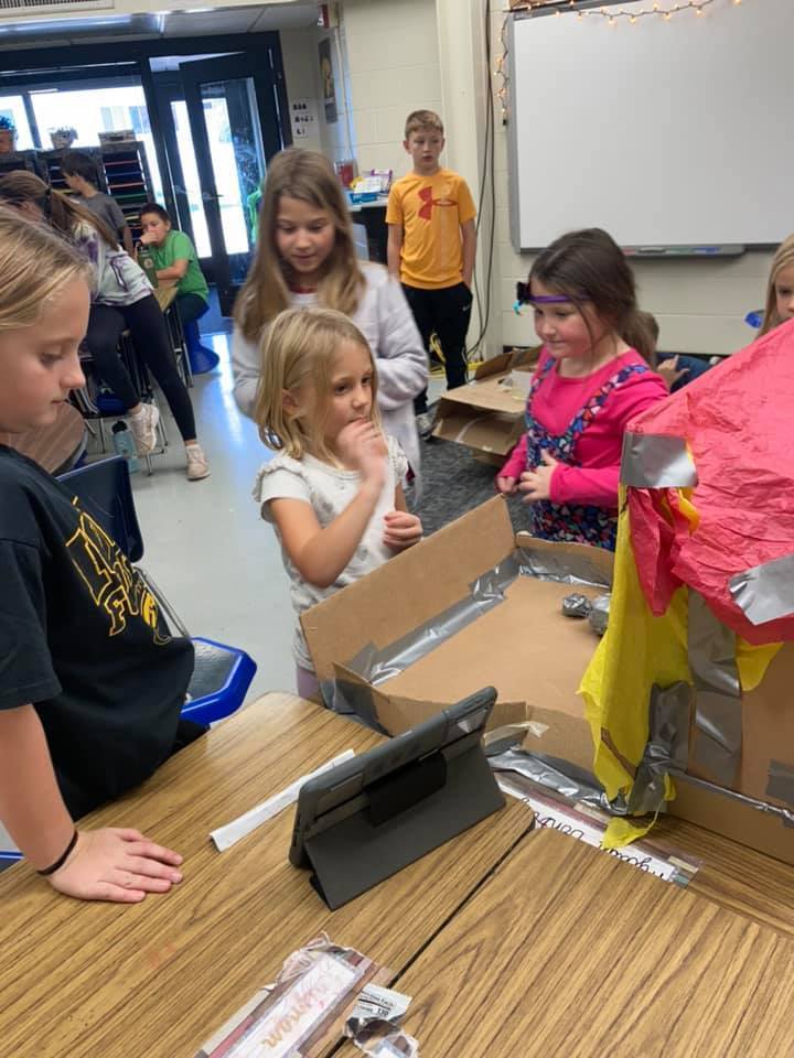 Students building cardboard games