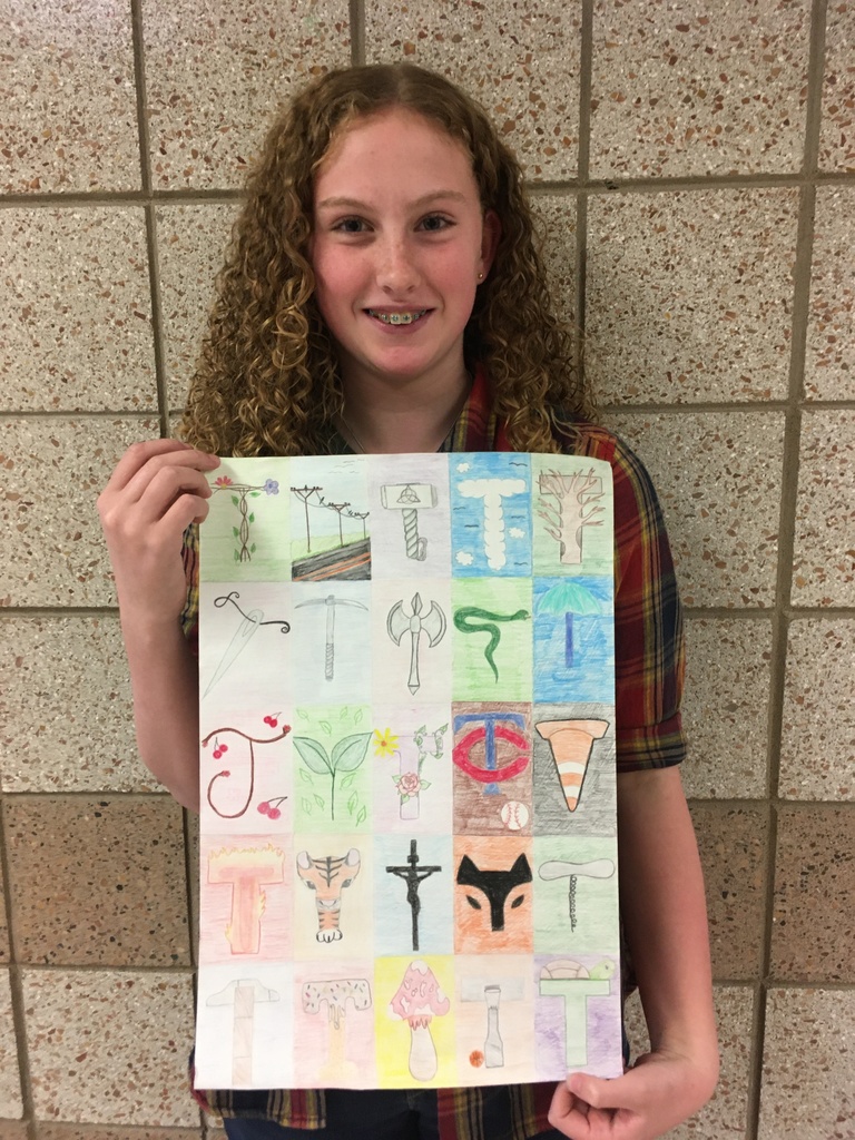 female student holding alphabet art