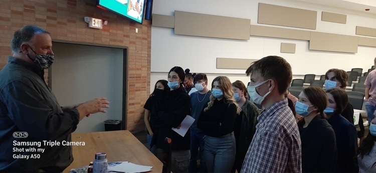 students listening to someone speak 