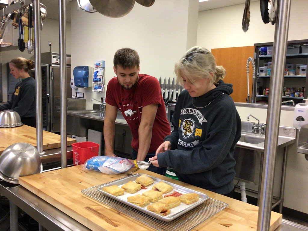 Students baking pastelitos