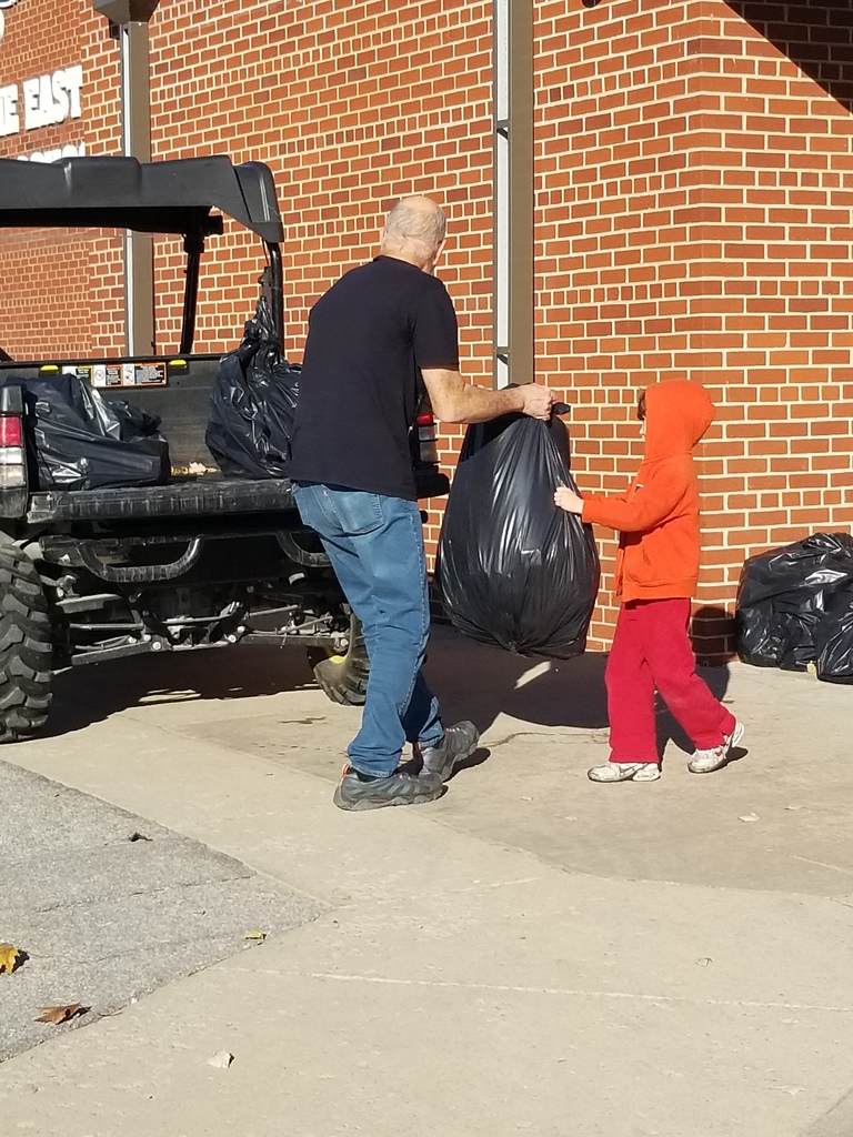 Student helping custodian with duties