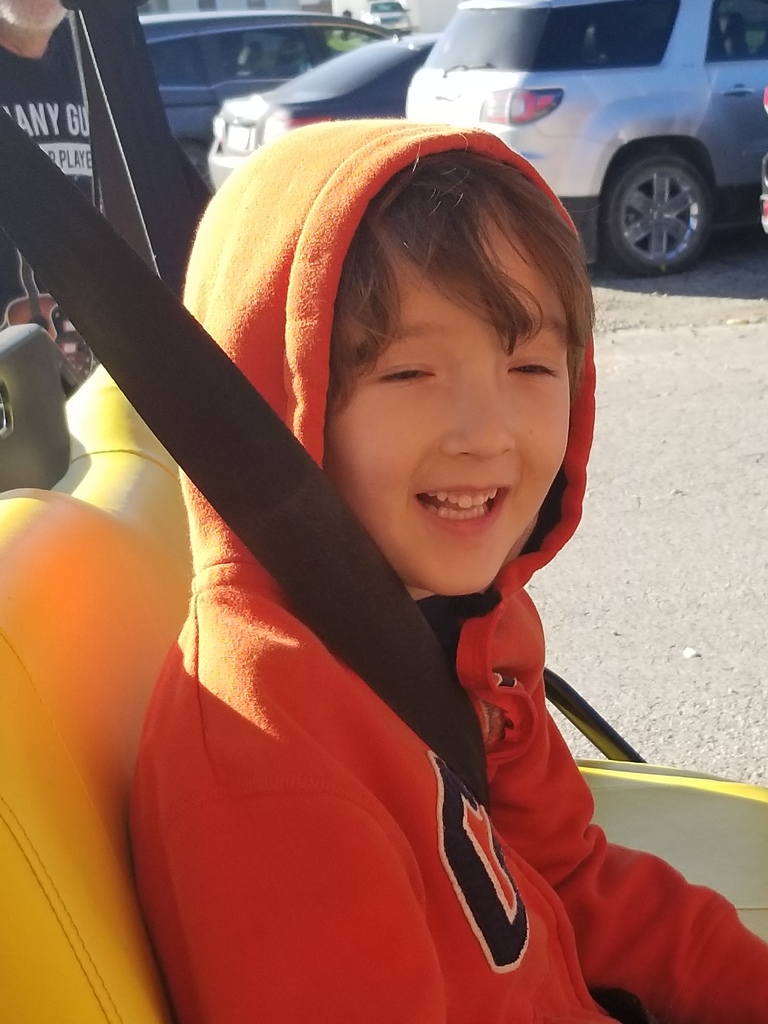 Student riding in Gator