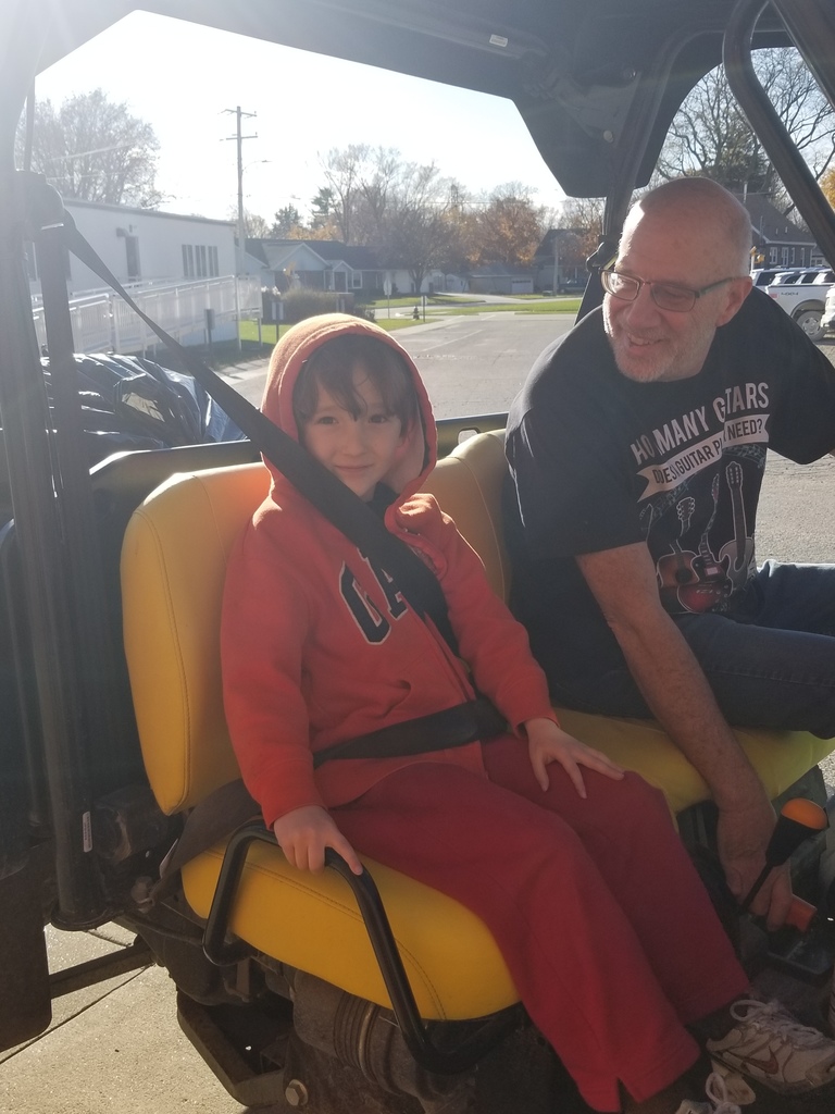 Student and custodian riding in Gator