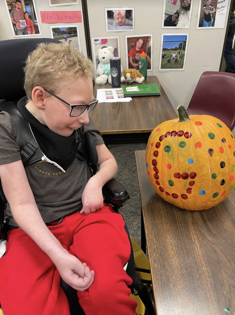 Student with painted pumpkin