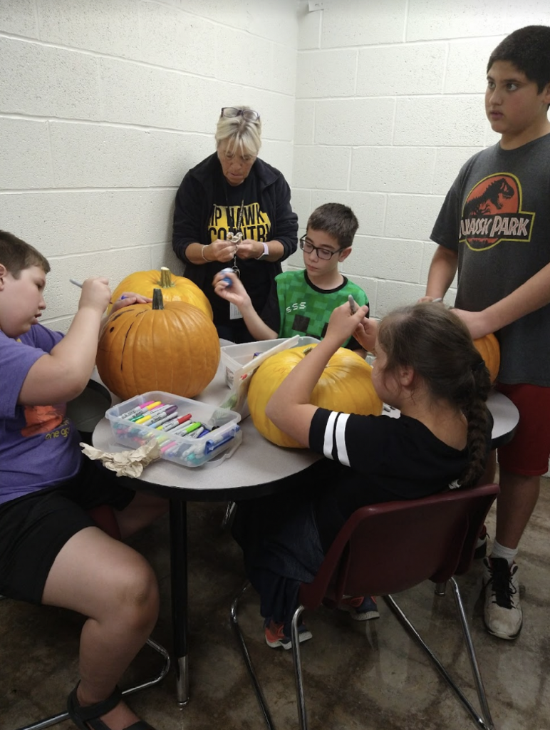 Students painting pumpkins