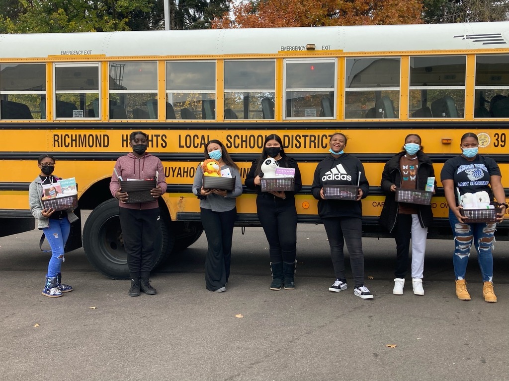 Students posing in front of the bus