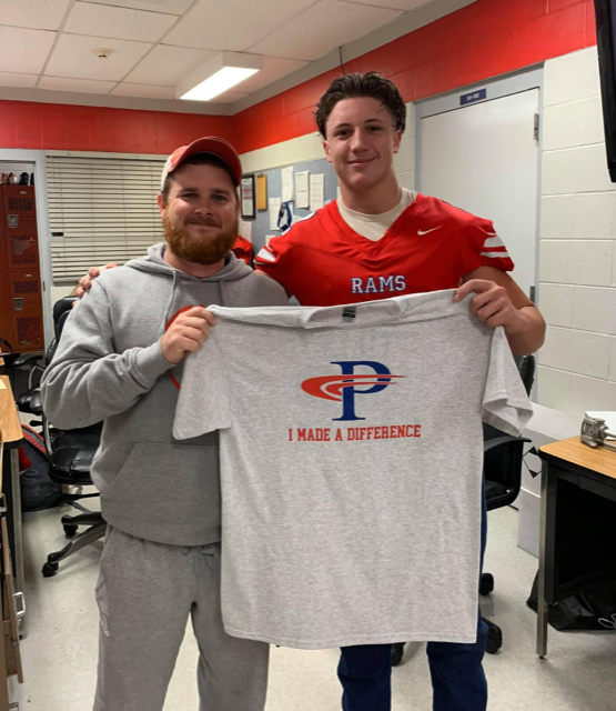 Teacher receiving I Made a Difference T-shirt