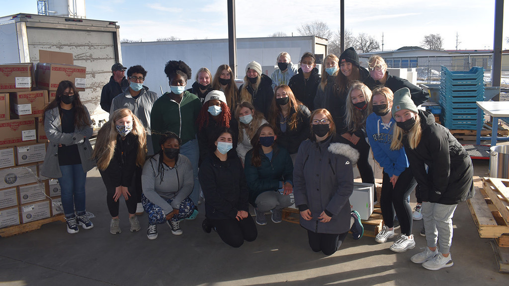 Students pictured dropping off food donations to Great Plains Food Bank