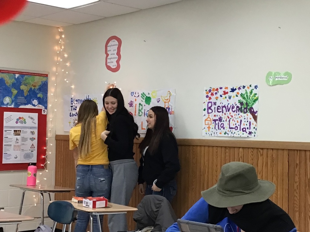 Students hanging up decorations in the classroom