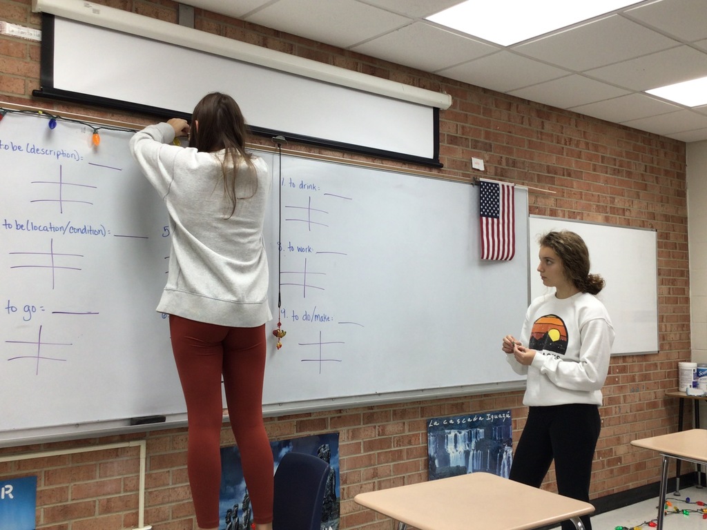 Students hanging up decorations in the classroom