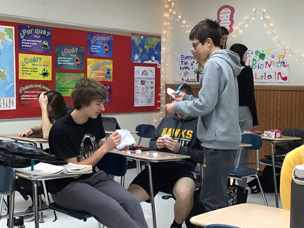 Students hanging up decorations in the classroom