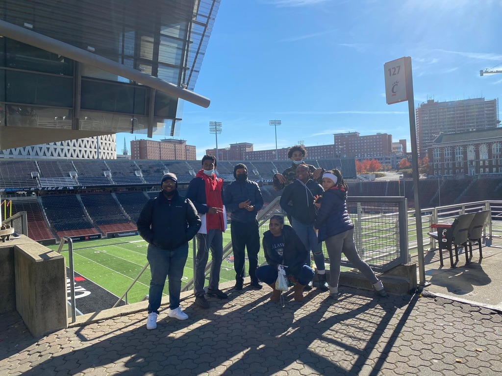 Students in front of the University of Cincinnati football stadium.