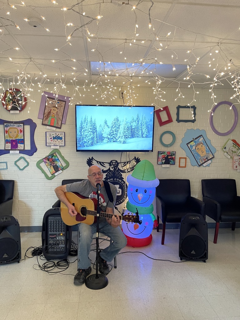 Mr. Mike singing Christmas carols in MP-East front hallway