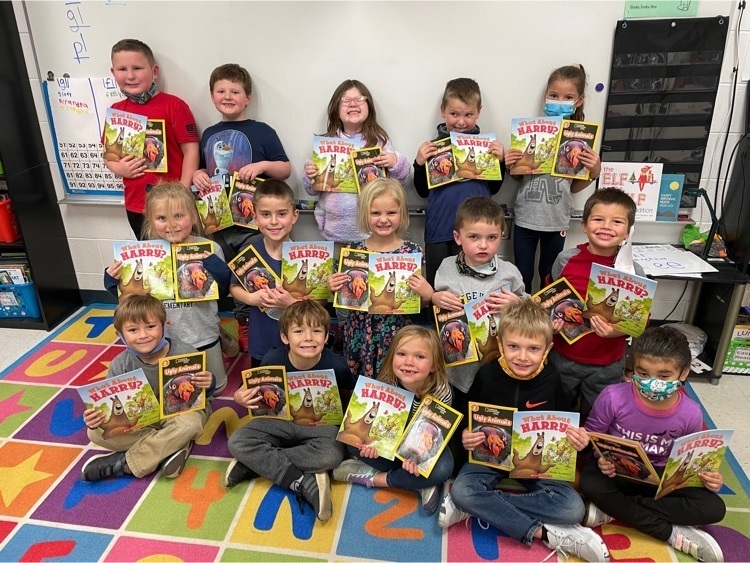 1st grade students with books