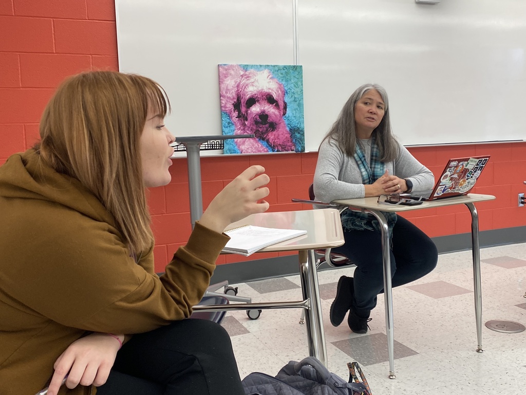 students talking to a teacher