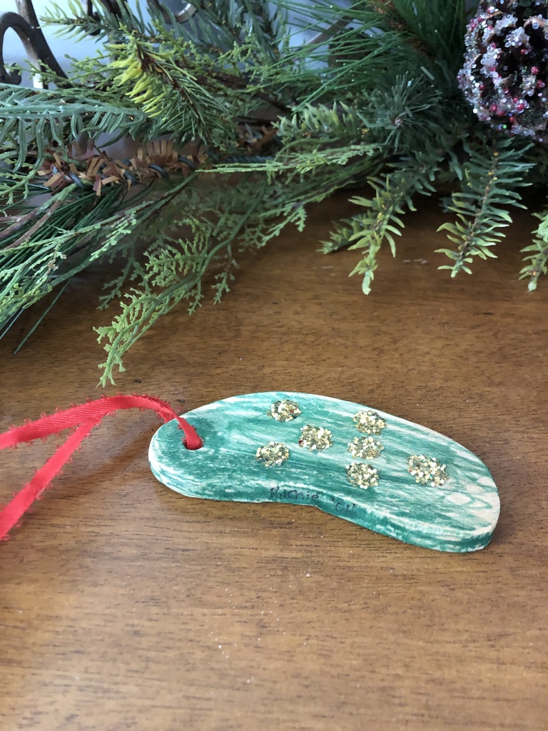 Handmade tree ornament in the shape of a pickle.